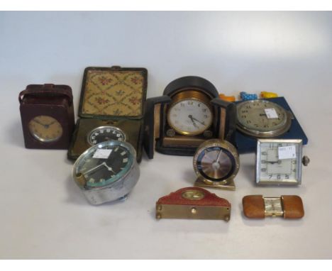 A collection of small clocks including an example by Zenith in a presentation case, a miniature carriage style clock in a lea