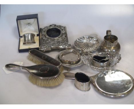 A collection of silverware including flatware, three small dishes, a small cream jug, a cased napkin ring, a pair of salts wi