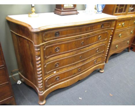 A 20th century walnut serpintine marble top commode with four long draws 95 h x 135 w x 58 d cm  