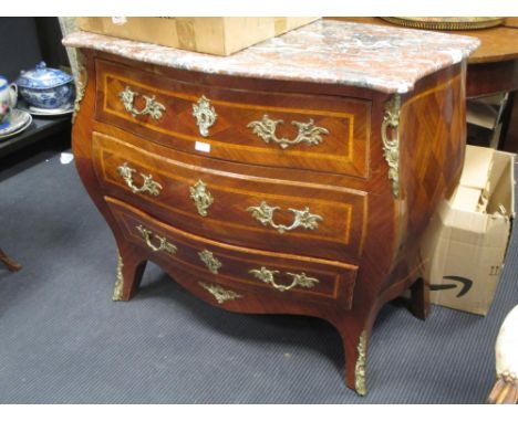 A marble topped bombe commode with gilt metal mounts on cabriole legs 97 cm wide  