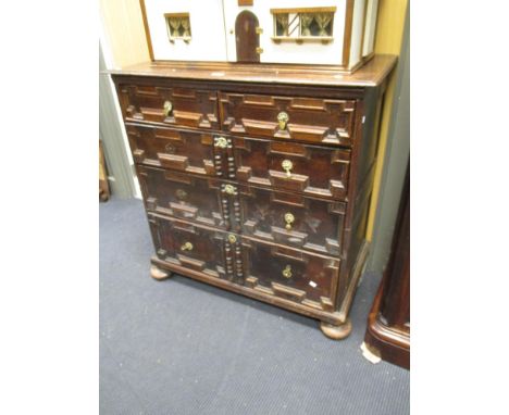 A 17th century oak chest of drawers, in two parts, with geometrically moulded front on bun feet, 96cm wide  