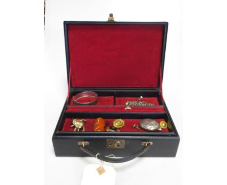A travelling jewellery box containing a quantity of jewellery including an 18ct ring, four unmarked brooches, a bangle, locke