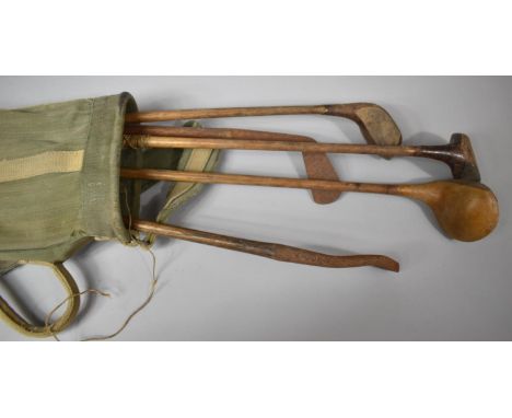 A Vintage Canvas Golf Bag Containing Five Wooden Handled Golf Clubs 
