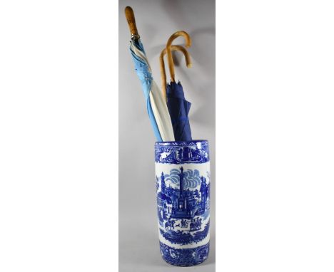 A Transfer Printed Blue and White Cylindrical Stick Stand Containing Walking Stick and Two Umbrellas, 44cm high 