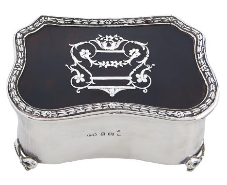 An Edwardian commode shaped silver inlaid tortoiseshell inset trinket box, on four paw feet, plush lined, 10cm l, marks rubbe