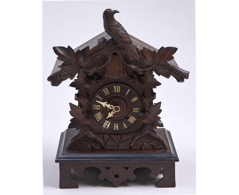 A German carved and stained softwood chalet form cuckoo clock, c1900, with bone hands and wire gong, 39cm h  Basically good, 