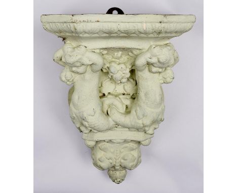 An architectural terracotta wall bracket, probably English, late 19th c, the shelf supported by two merboys with fruit and co
