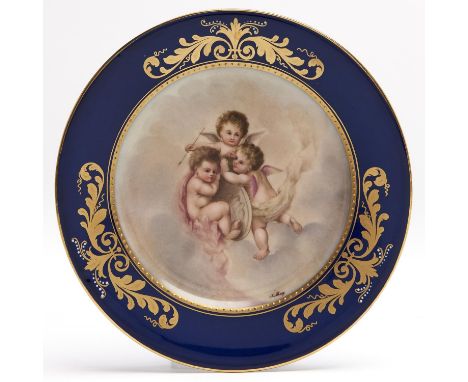 A Vienna style cobalt bordered plate, c1900, printed and painted with three amorini, signed J Larcy and gilt, 18.5cm diam, bl