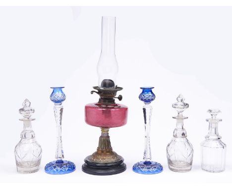 Two blue flashed and cut glass candlesticks, 32cm h, a late Victorian brass oil lamp with cranberry glass fount and one and a