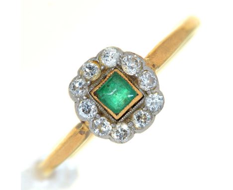 An emerald and diamond cluster ring,&nbsp; gold hoop marked 18 Plat, 2g, size R  Emerald with wear to facets evident under 10