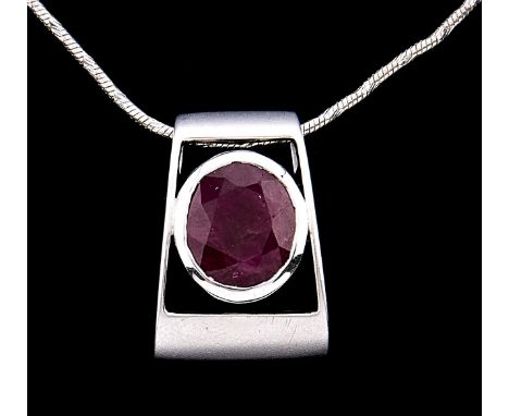 A ruby pendant, of axe head shape in white gold, unmarked, on white gold necklet, marked 750, 6.4g  Good condition