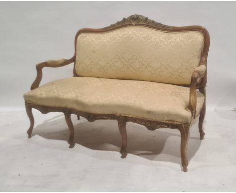 French-style settee with shell carving to top rail, foliate and yellow upholstered seat, back and arm rests, serpentine front