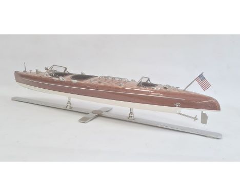 An early/ mid 20th century model runabout boat with lift up hatch to reveal model engine, on a chrome stand, 84cm long approx