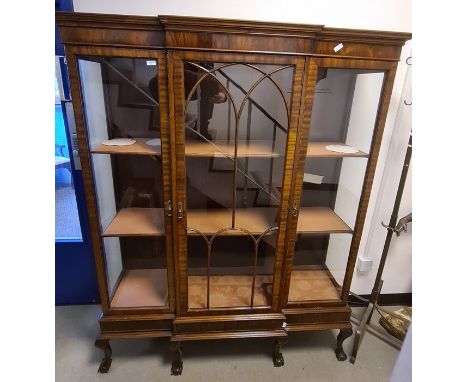 20th century mahogany breakfront display cabinet with ogee moulded cornice above central astragal-glazed door, flanked by two