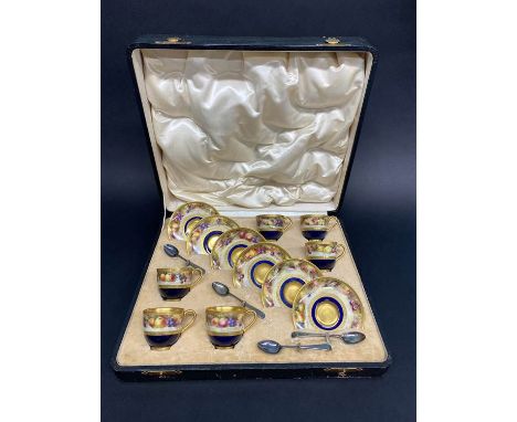 A cased Royal Worcester six setting fruit pattern coffee service by Frank Roberts, dated 1918, six silver coffee spoons, Coop