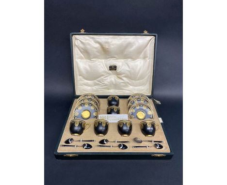 A cased Royal Worcester six setting coffee service, dated 1925, with set of six silver enamelled Norwegian spoons
