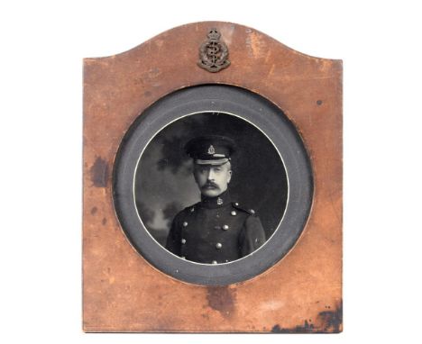 GREAT WAR - ROYAL ARMY MEDICAL CORPS  A Leather Photograph Frame containing a circular black and white image of a Major of th