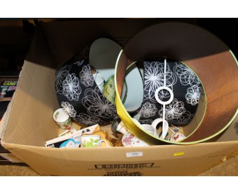 A box containing light shades; a pottery watering can; mugs and other sundries