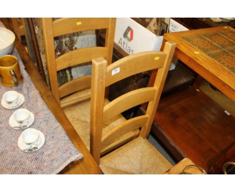 A set of eight ladder back and rush seated dining chairs