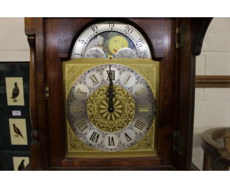 An Emperor long case clock with pendulum and weights