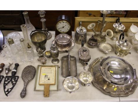 A large quantity of various silver plated ware; a silver backed mirror; mahogany mantel clock etc. 