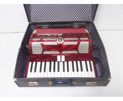 Paolo Soprani thirty-four key, seventy-two bass piano accordion, in marbled red, with strap and carry case. Circa 1960's.