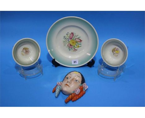 A decorative porcelain wall mask and four pieces of Susie Cooper.