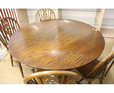 An Ercol style drop leaf table and 4 chairs.