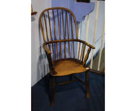 A stick back Windsor chair.