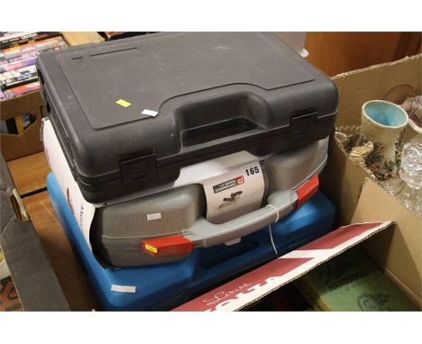 Three cased power tools.