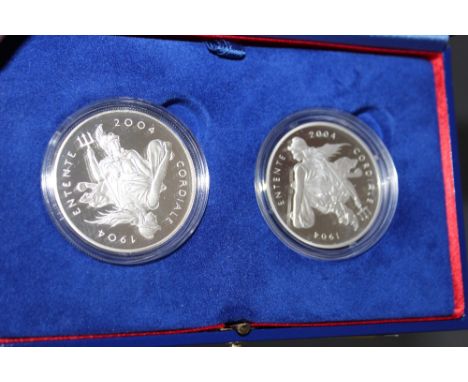 A ROYAL MINT '100TH ANNIVERSARY OF THE ENTENTE CORDIALE' SILVER PROOF £5 TWO COIN SET, with COA/Booklets, in original present