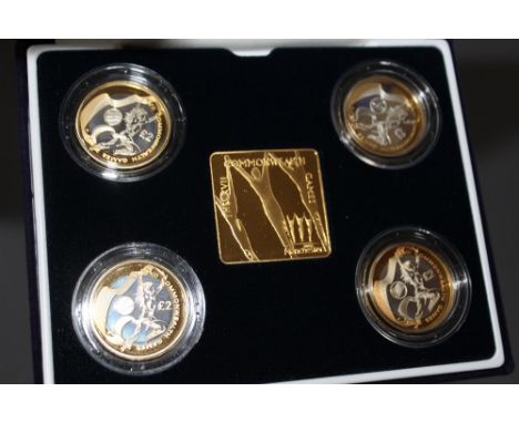 A ROYAL MINT 2002 'COMMONWEALTH GAMES' SILVER PROOF FOUR COIN SET TOGETHER WITH A GOLD PLATED PLAQUE, comprising £2 (4), with