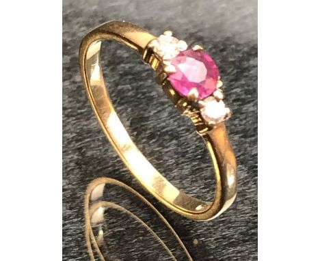 9ct Gold ring set with a single ruby and with Diamond shoulders size M