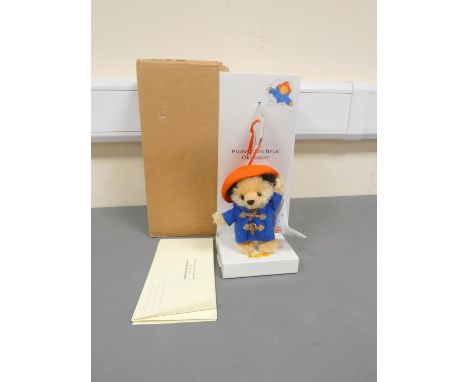 Steiff. Paddington Bear Ornament, 2004, white tag 354373, beige mohair with blue toggle coat and hat. Complete with swing cer