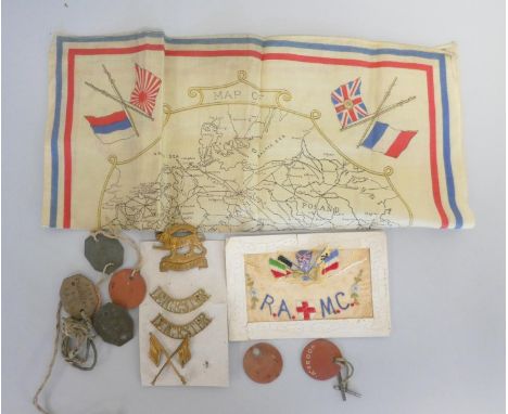 WW1 militaria to include regimental badges, a Royal Army Medical Corps silk postcard, a WW1 map of Europe teatowel, and a col