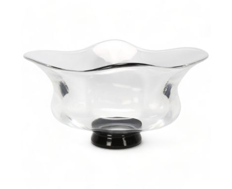 SIMON GATE for Orrefors, Sweden, a clear glass lobed bowl on black foot, marked to base Of 32 G.U.57., length 27cm1 small dee