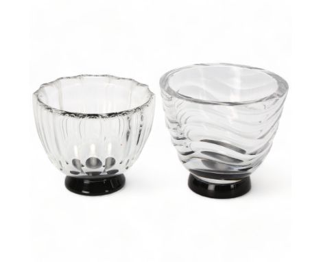 SIMON GATE for Orrefors, Sweden, two 1930s clear glass bowls on black foot, both with makers mark to base, largest diameter 9