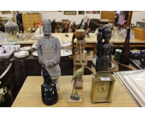 Two carved wooden ethnic ornaments; a Chinese style warrior figure; a brass cased clock etc. 