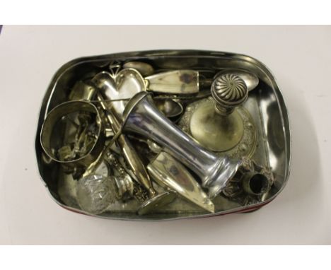 A tin of mixed silver and plated ware to include a vesta case, a pocket watch, spill vase, cutlery etc. 