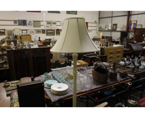 A painted wooden standard lamp and shade