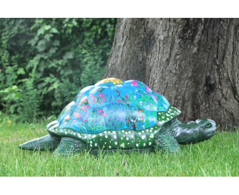 All is well, all is calm, as Tusti the tortoise is covered in every plant that will help her feel good. Plants to eat, plants