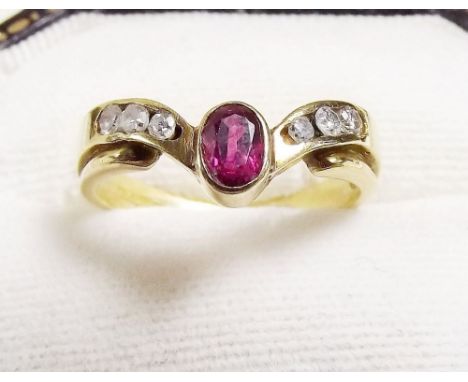 An 18 carat gold ruby and diamond wishbone ring