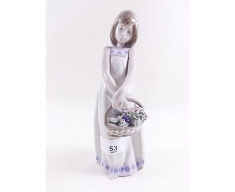 A Lladro figure of a girl with a basket of flowers 