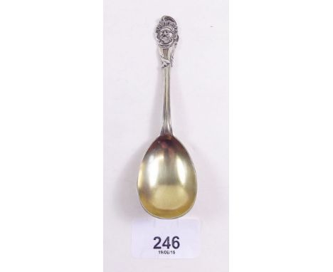 A silver gilt caddy spoon with mask terminal
