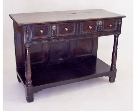 A late 17th century oak serving table  with two panelled frieze drawers applied split bobbin turned decoration all over lower