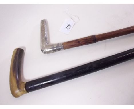 A silver handled walking stick and a horn handled ebony one