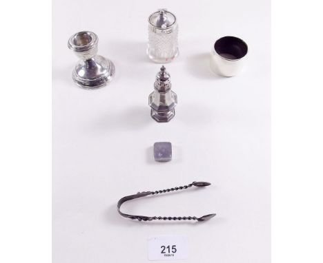 A group of small silver items including candlestick, salt, tongs etc