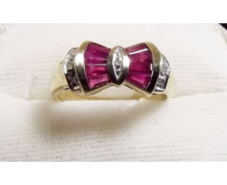 A 9 carat gold ruby and diamond bow design ring