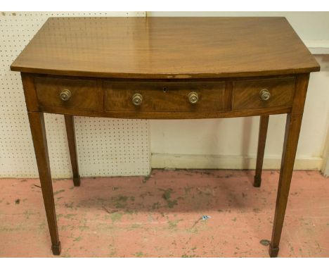 BOWFRONT WRITING TABLE, George III mahogany with three drawers, 73cm H x 84cm W x 50cm D. 