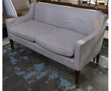 SOFA, of compact proportions in a loose linen style cover on square tapering supports castors, 85cm H x 155cm x 68cm. 